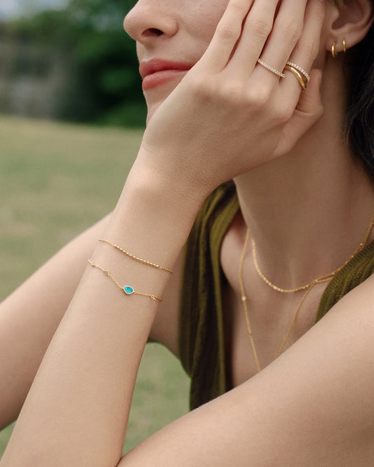 Turquoise discs gold bracelet worn on wrist