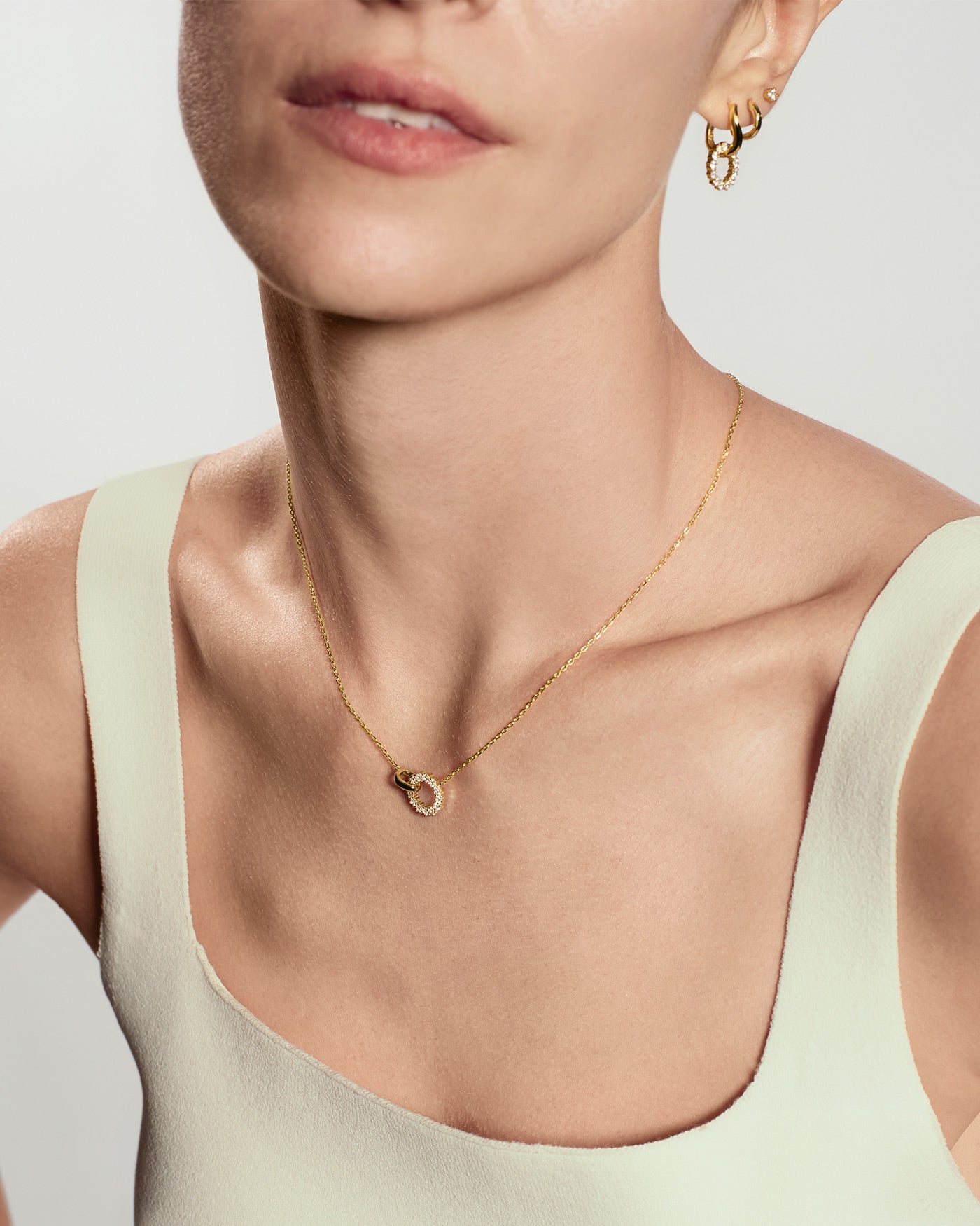 Gold interlinked circles pavé necklace worn on neck