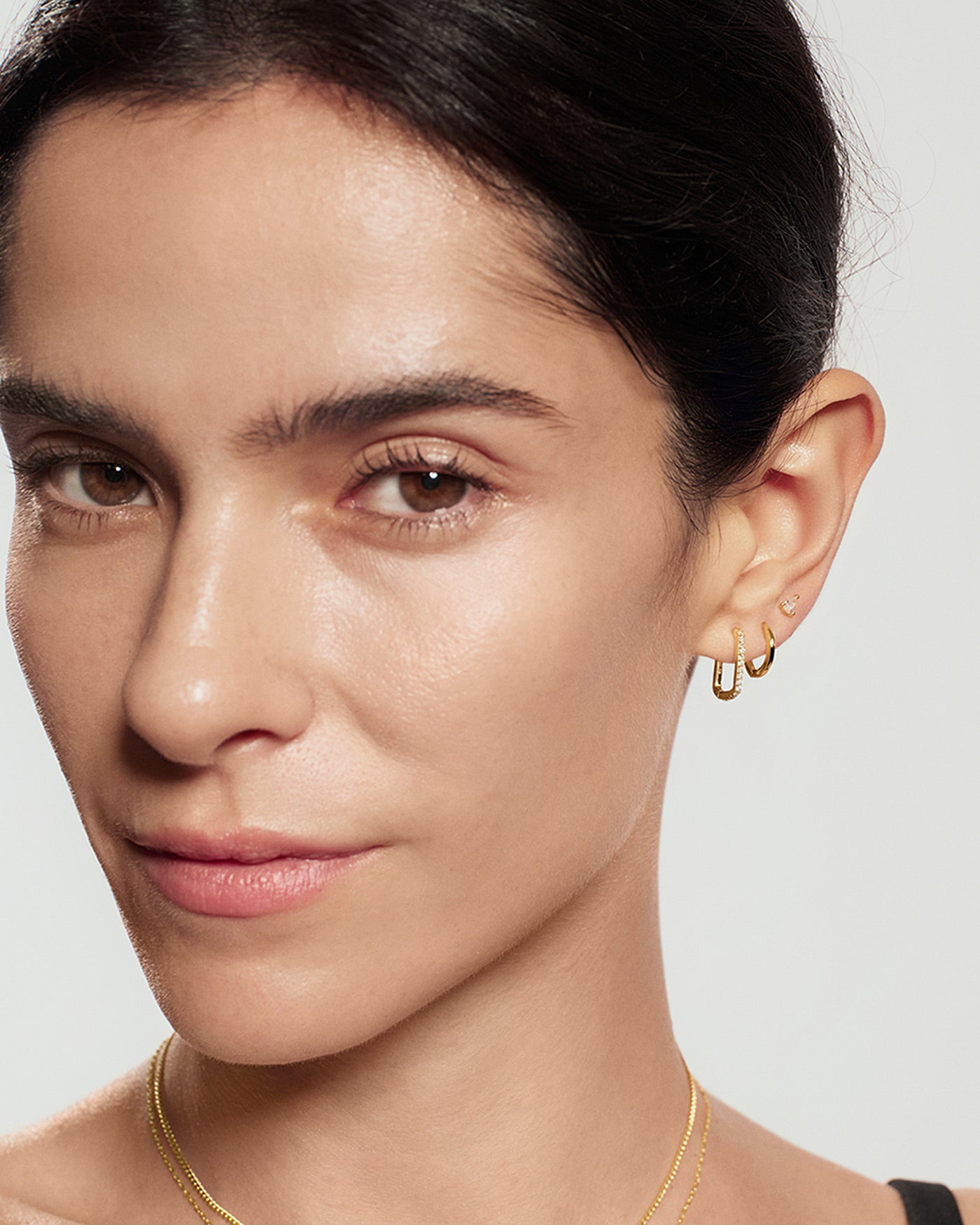 Gold Glam Oval Hoop Earrings worn on ear